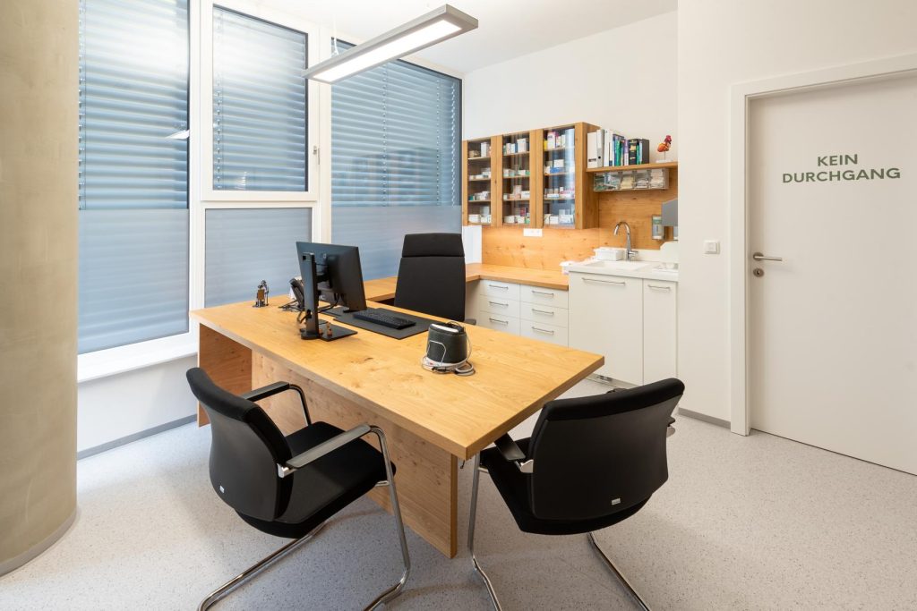 Eleganter Cheftisch mit hochwertigen Sesseln und modernem Arbeitsplatz sowie individuelle Regal und durchdachtes Design